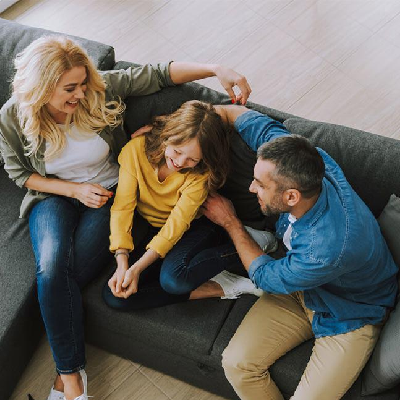 Family relaxing together on the couch in a warm home after a fall HVAC tune-up in Celina, Texas.